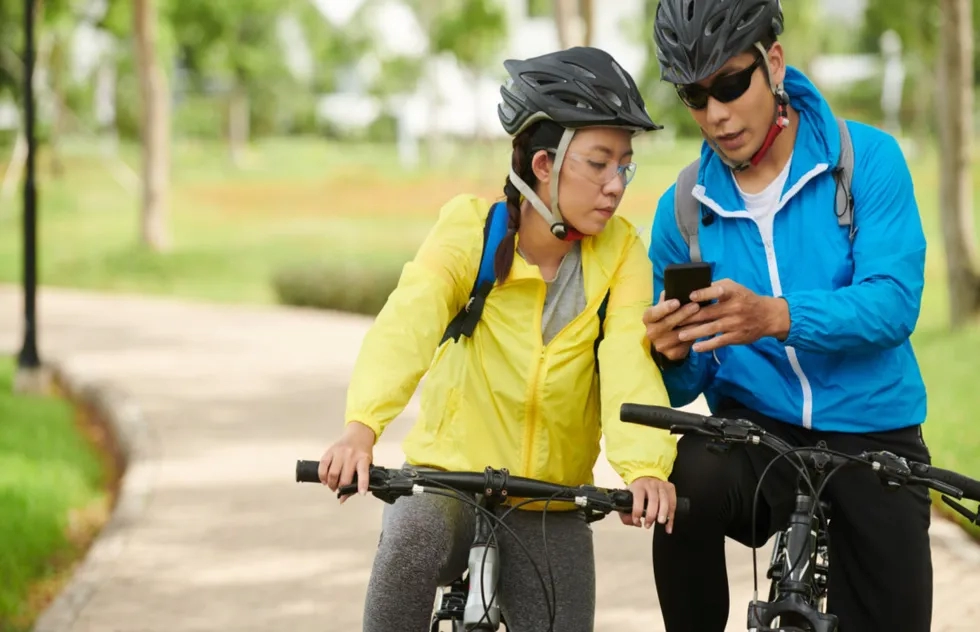 couple pauses bike ride to check phone