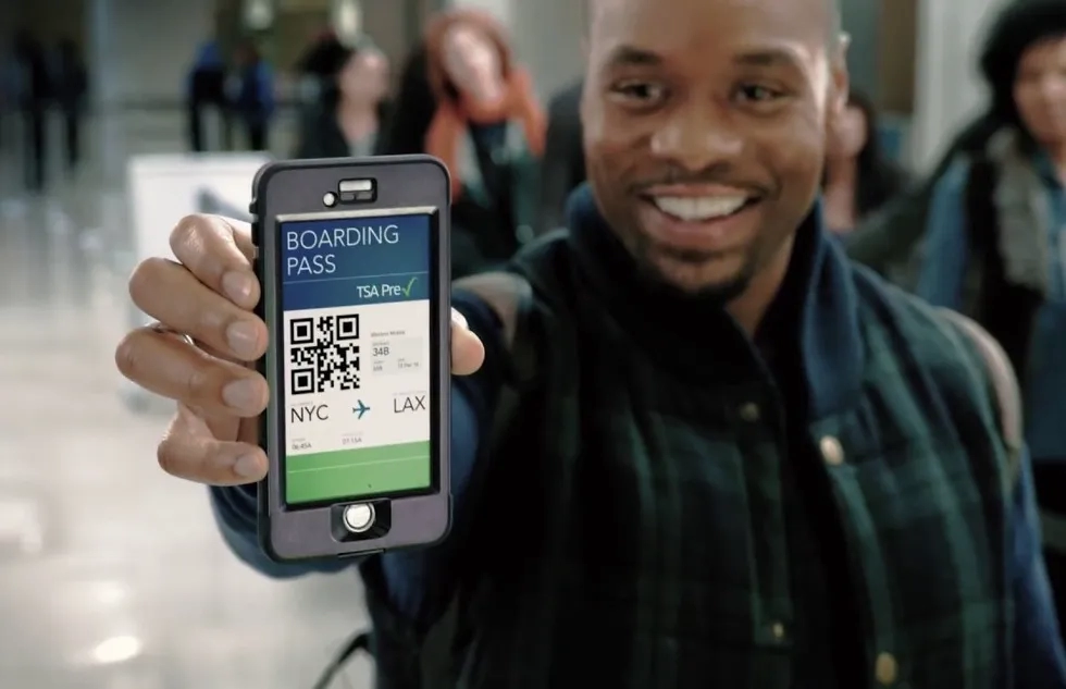 Passenger holding up TSA PreCheck mobile pass