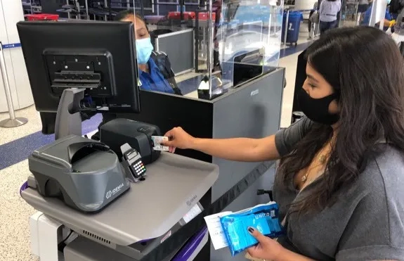 Passenger scans her identification at touchless ID TSA checkpoint, LAX