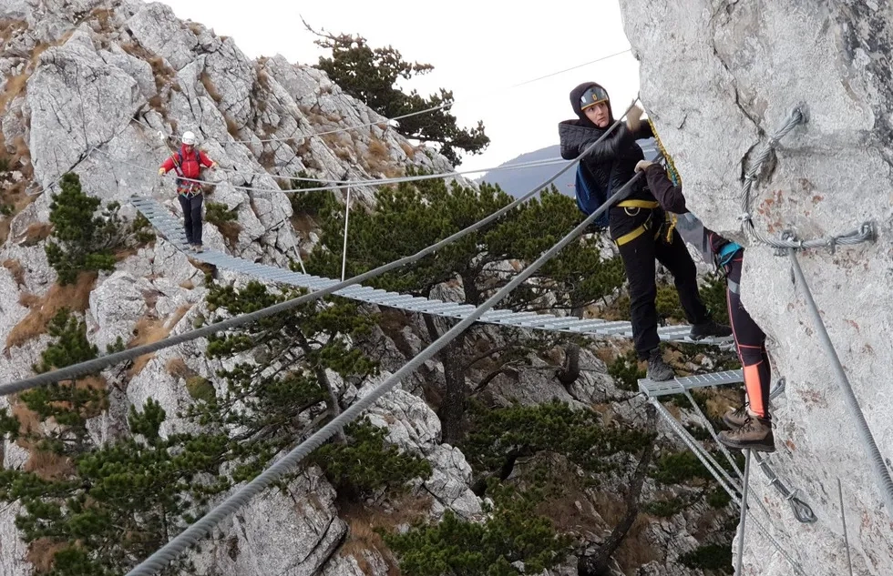 Via Ferrata suspension bridge with hikers, Kosovo
