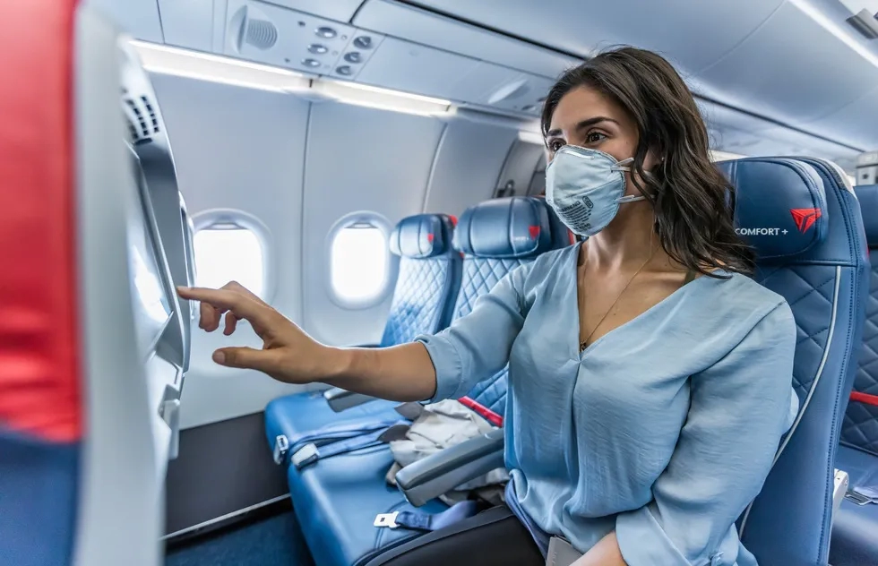 female passenger alone wearing mask on Delta flight (Economy)