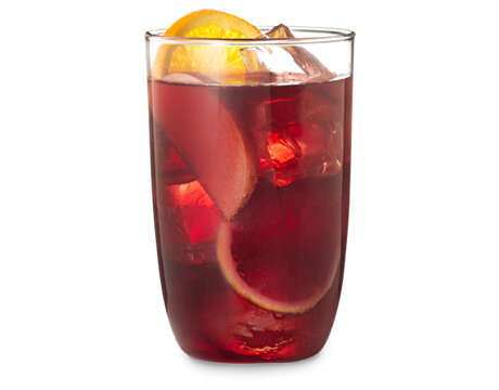 Holiday Sangria in a clear glass with garnish