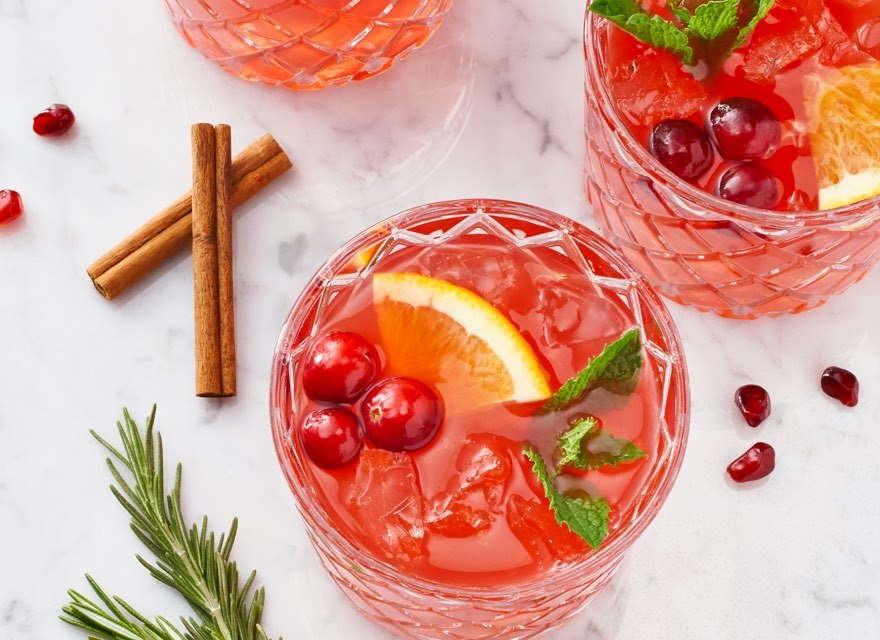 cranberry cocktails with fresh cranberries and lemon wedges