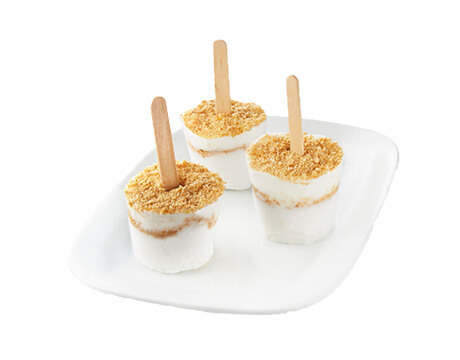 three Key Lime Popsicles on a white plate