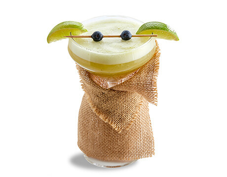 kiwi limeade cocktail in cloth wrapped glass and garnish