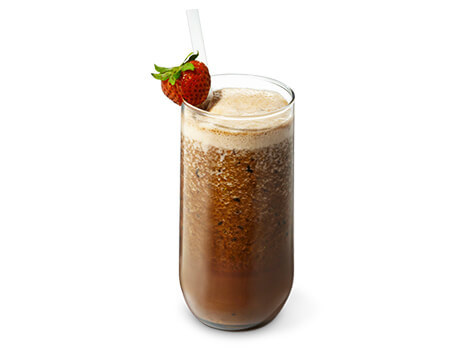 Cinnamon Acai Smoothie in a clear glass with a strawberry garnish
