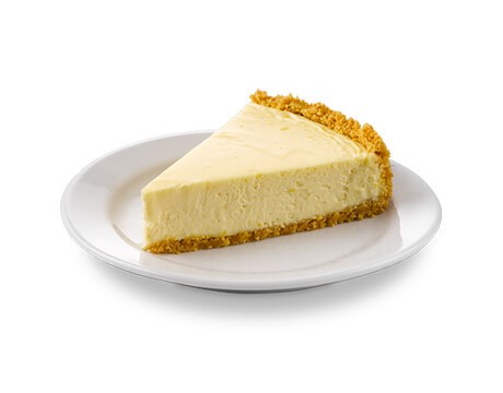 Slice of classic cheesecake on a white serving dish