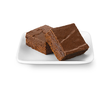 Two delicious fudgy brownies on a small white serving plate
