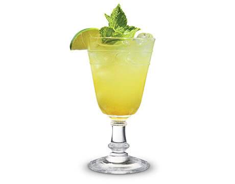 Ginger mint margarita in a clear glass with garnish