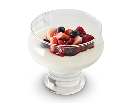 Italian Style Buttermilk Custard or Panna Cotta in a glass dish with berries