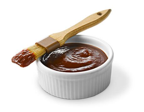 Kansas City BBQ Sauce in a white dish with brush