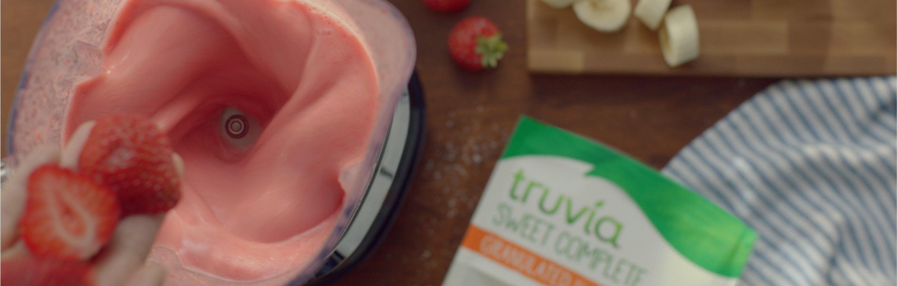 Top view of a blender full of strawberry banana smoothie made with Truvia sweet complete
