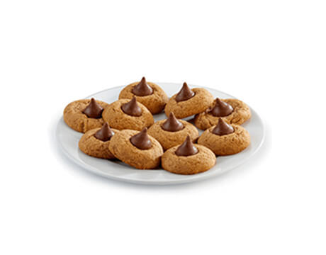 Plate full of almond thumbprint cookies with chocolate kisses