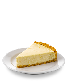 Slice of classic cheesecake on a white serving dish