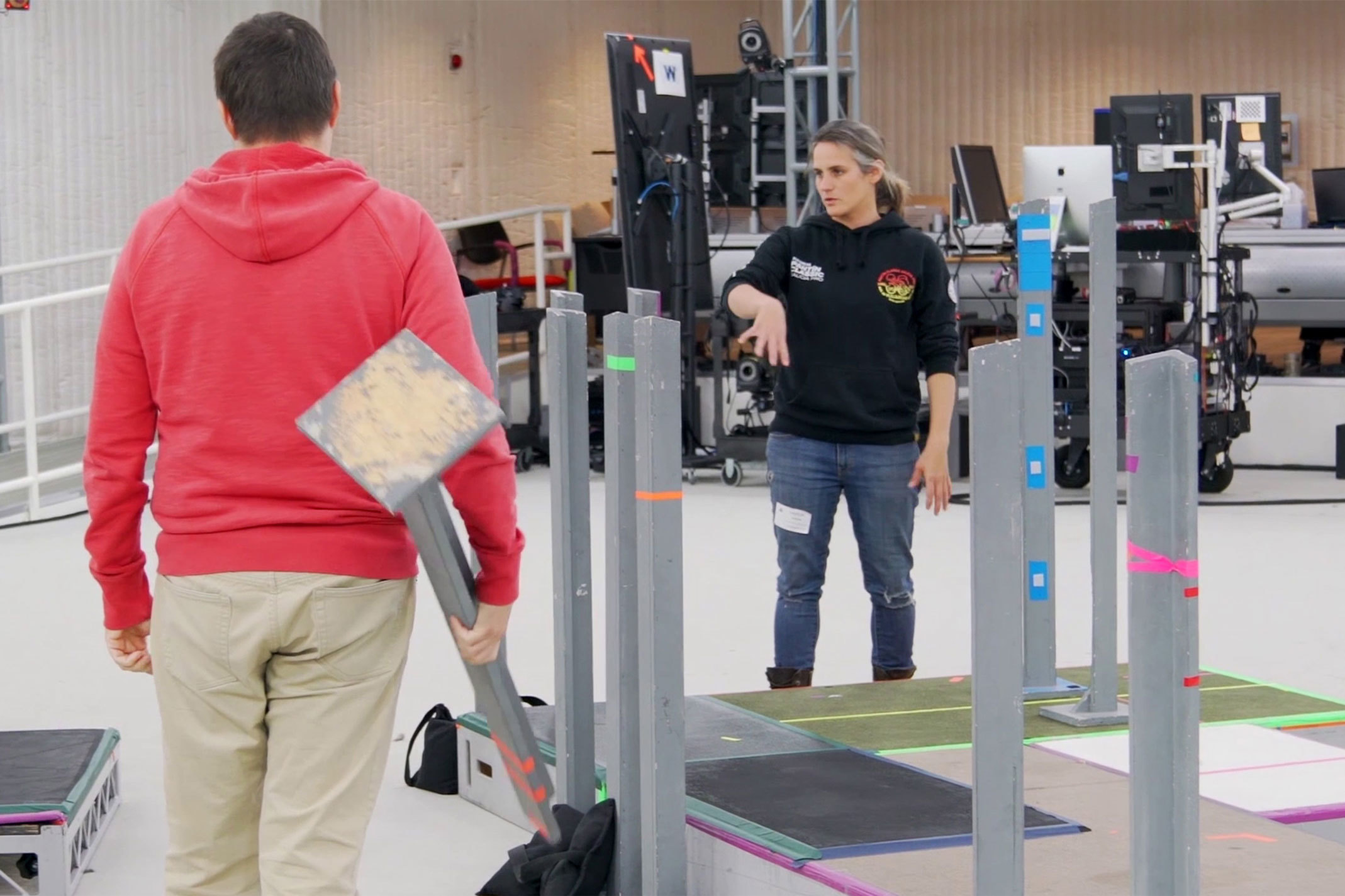 Two developers pictured in a sound stage putting together a scene for motion capture