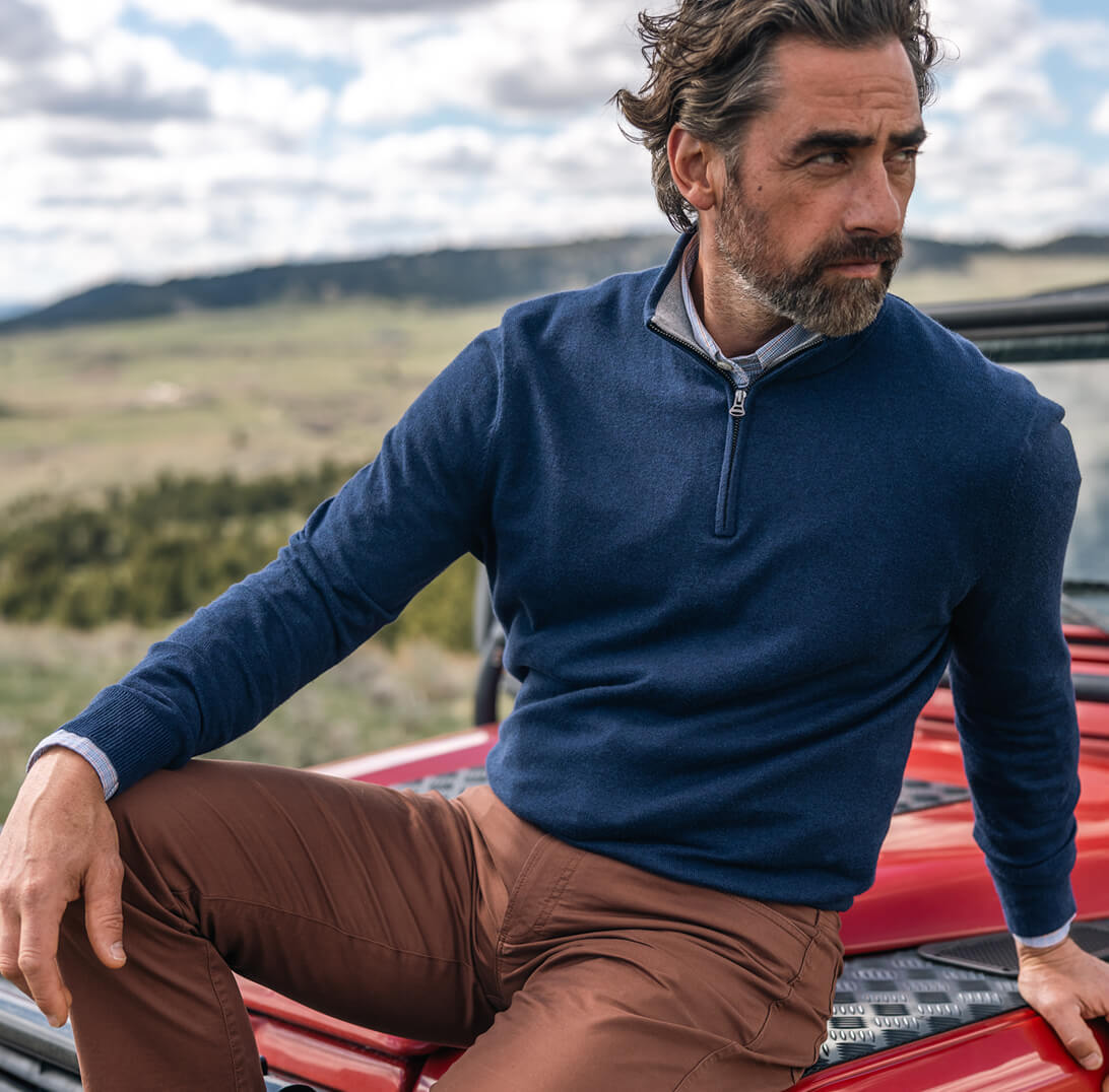 Man sitting on red jeep
