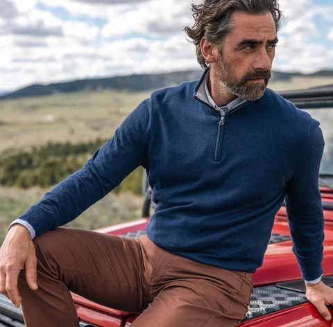 Man sitting on red jeep
