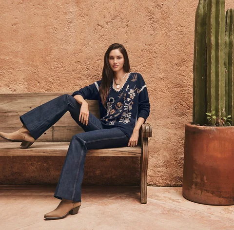 Johnny Was model sitting on bench