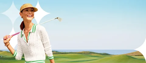 Women holding golf club on golf course