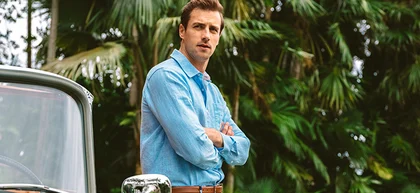 Man leaning against retro car