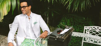 Man sitting at table in white suit