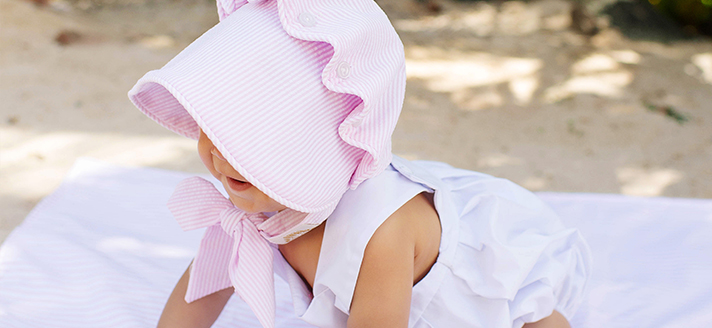 Baby wearing pink bonnet