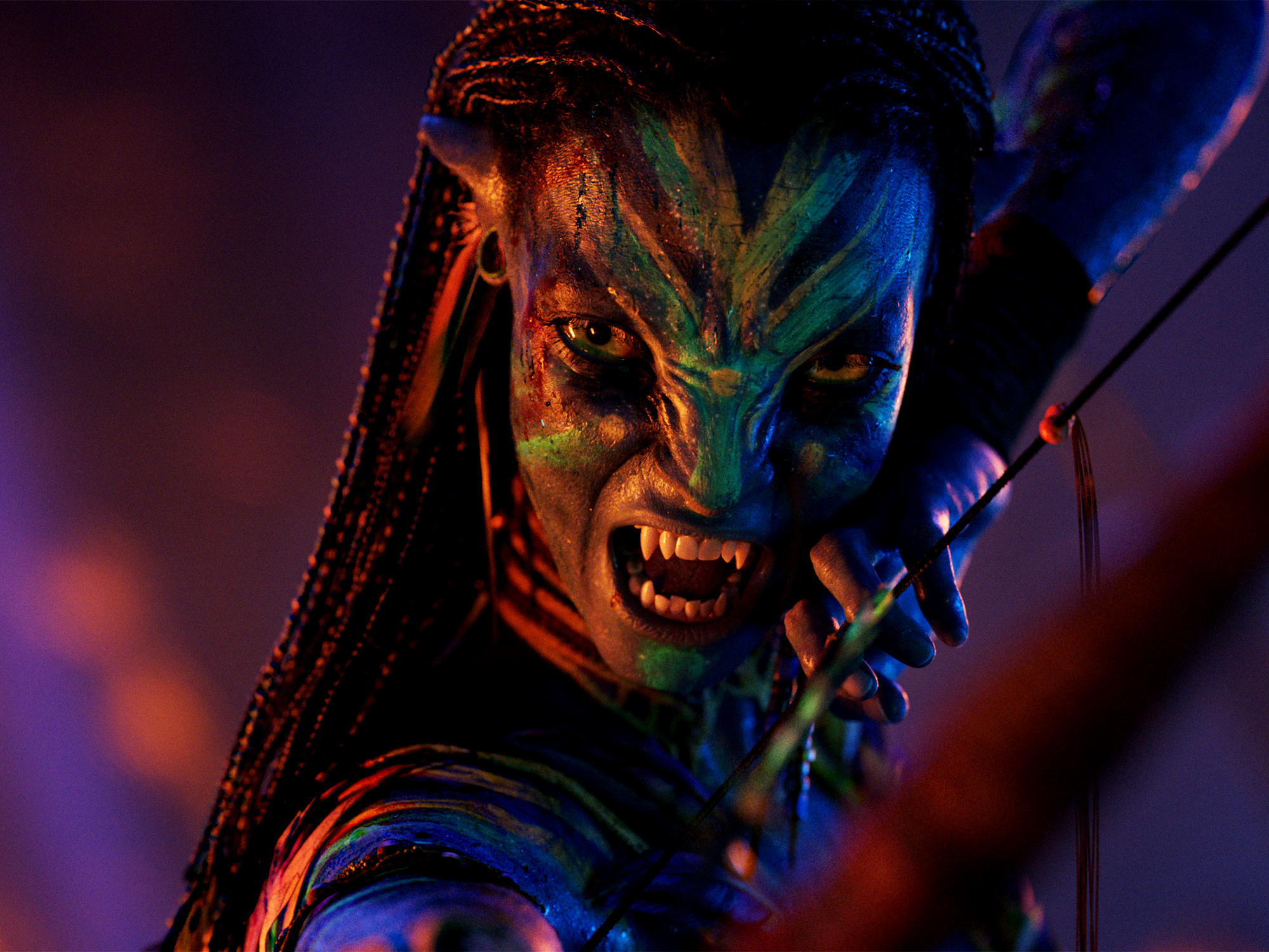 Blue and orange alien warrior with dreadlocks, fanged teeth, holding metal weapon. Dramatic lighting with purple background.