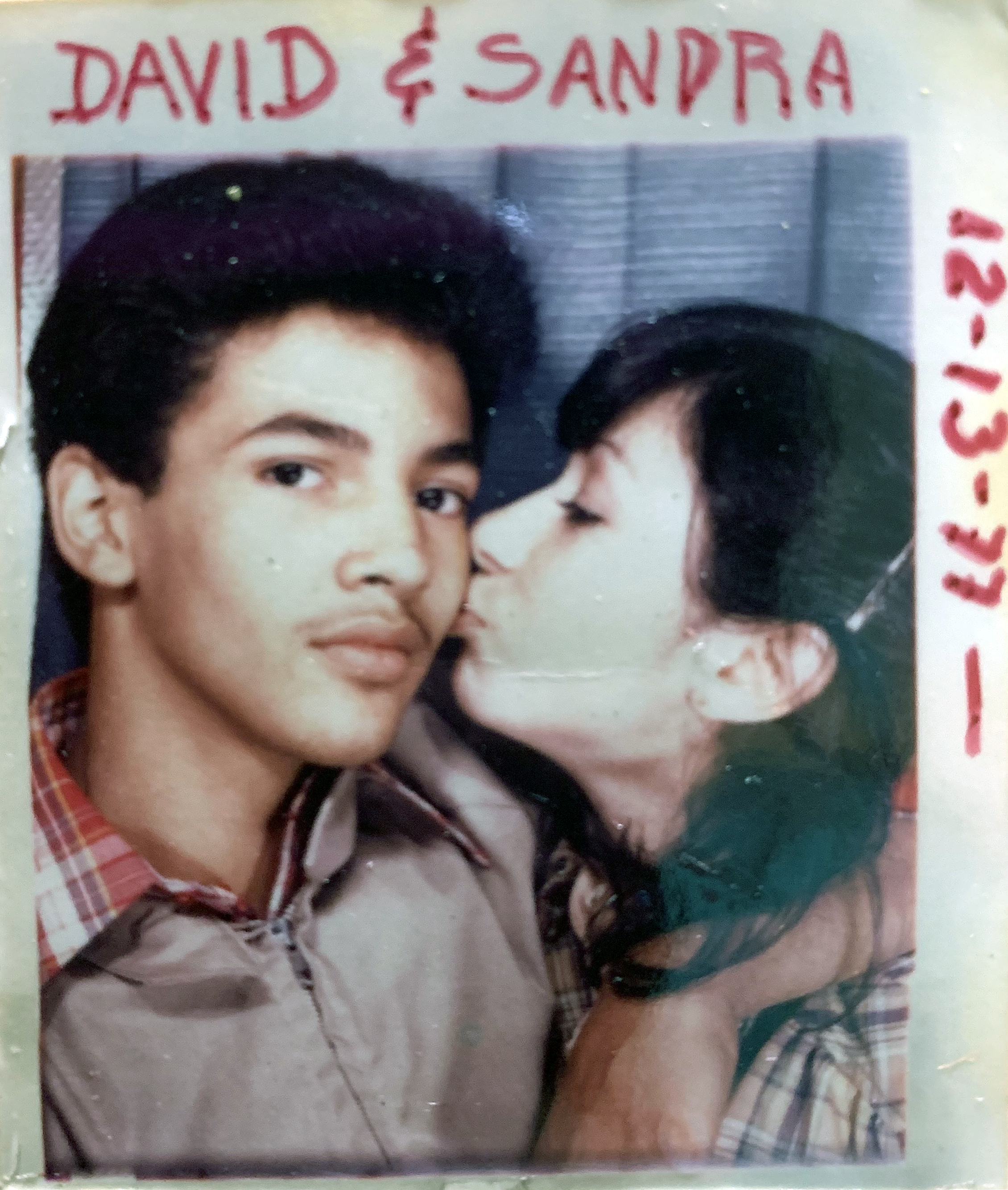 Vintage colour snapshot of young man and woman in close embrace. Red text "DAVID & SANDRA" at top, date "12-13-92" on right edge.