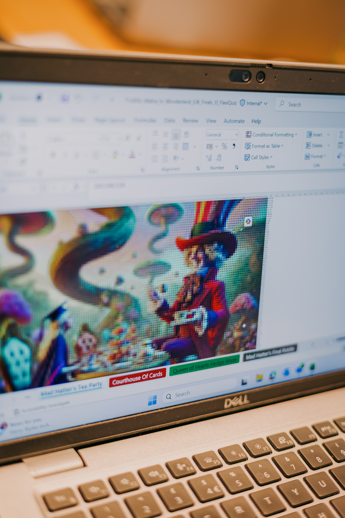 Laptop screen displaying colourful animated game with character in red coat and blue hat, web browser interface visible above.