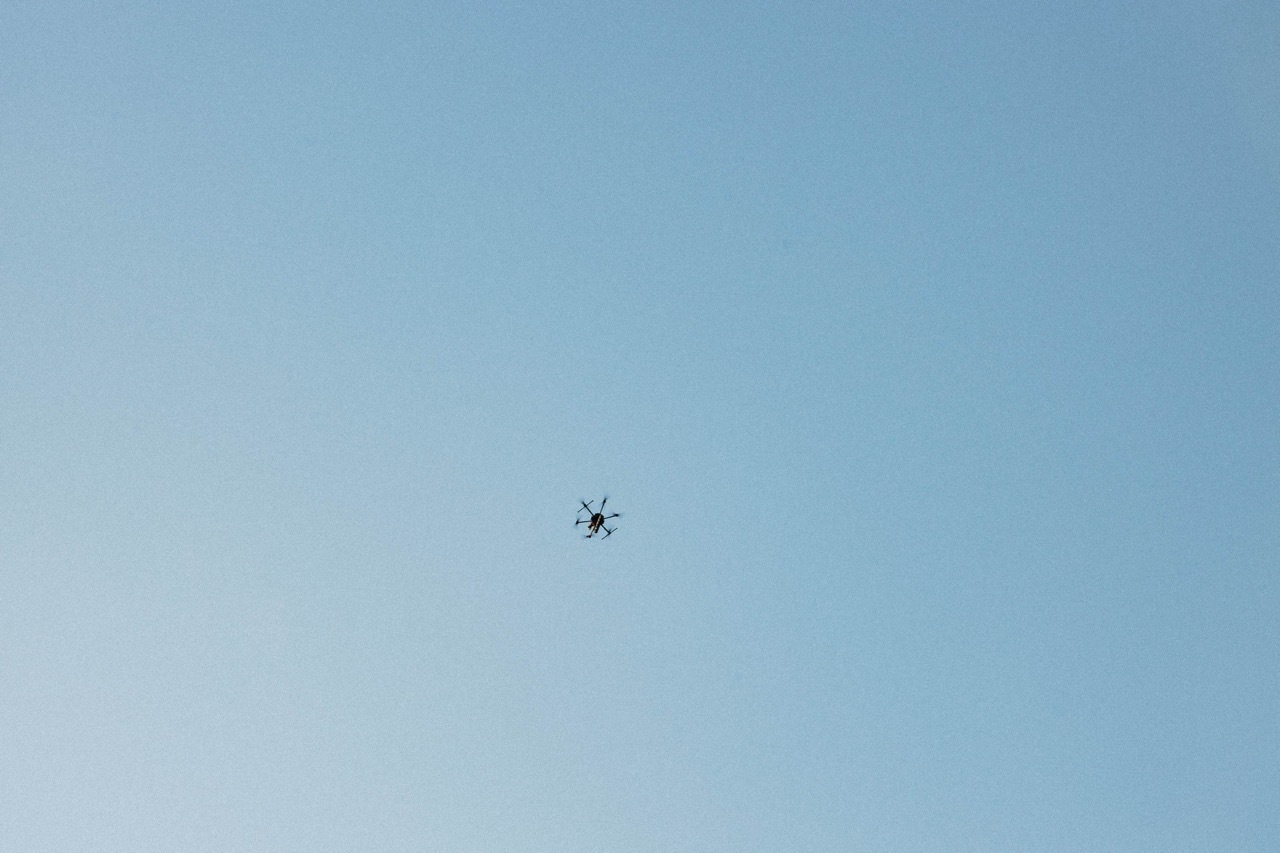 Small drone in clear sky.