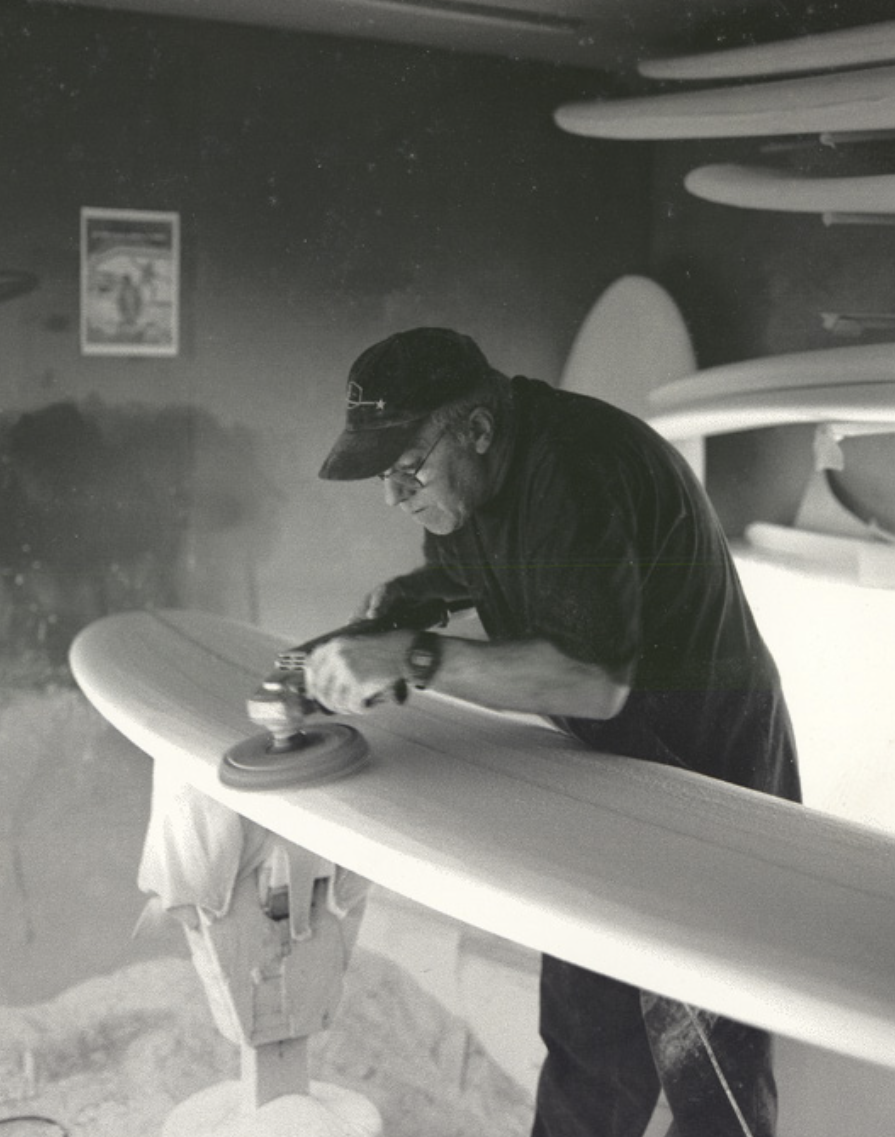 Man wearing a cap working on a table.