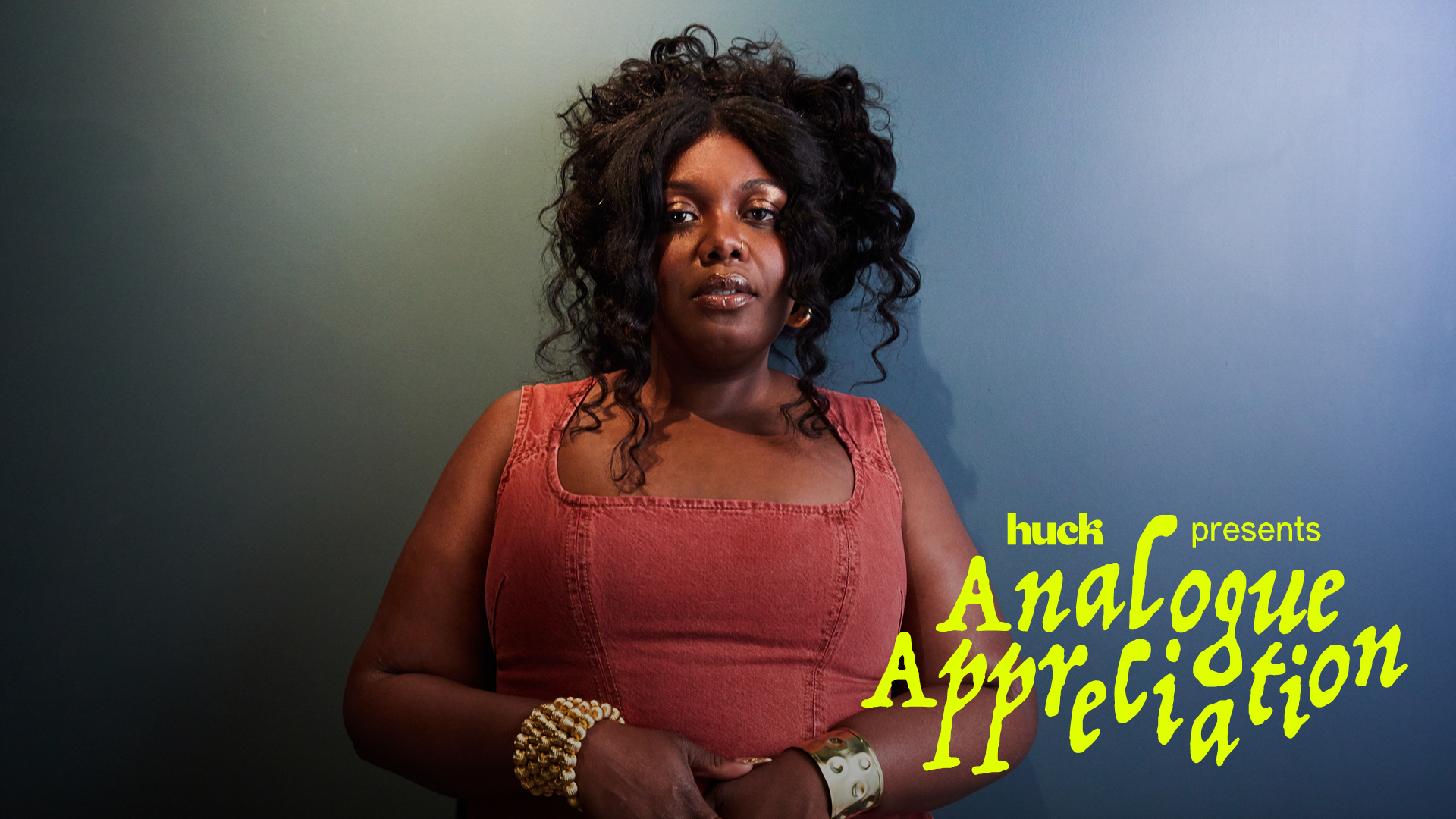 Black woman with curly hair in red top against blue-green gradient background. Yellow text reads "huck presents Analogue Appreciation".