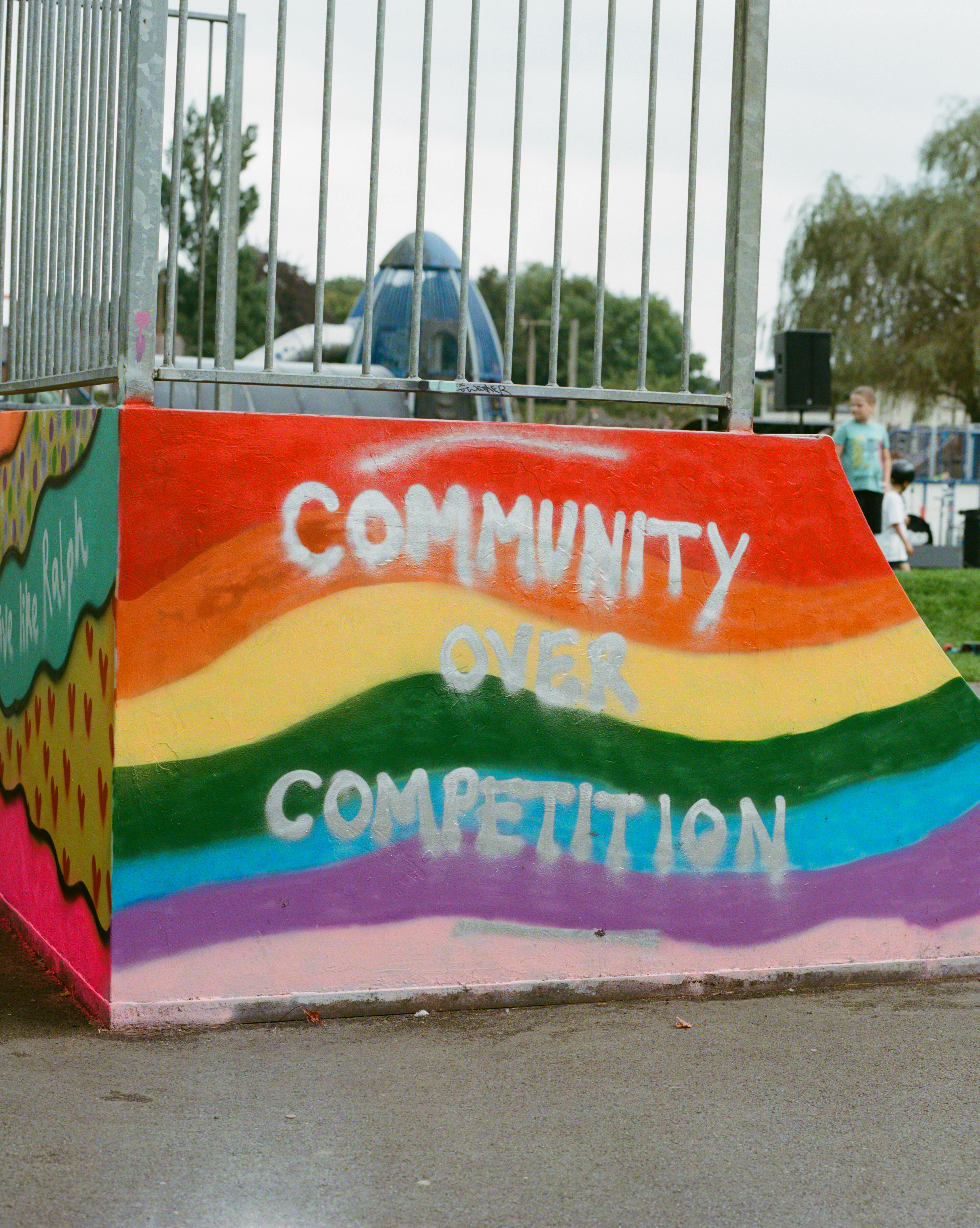 Brightly coloured, rainbow-themed banner with the text "Community Oven Competition".