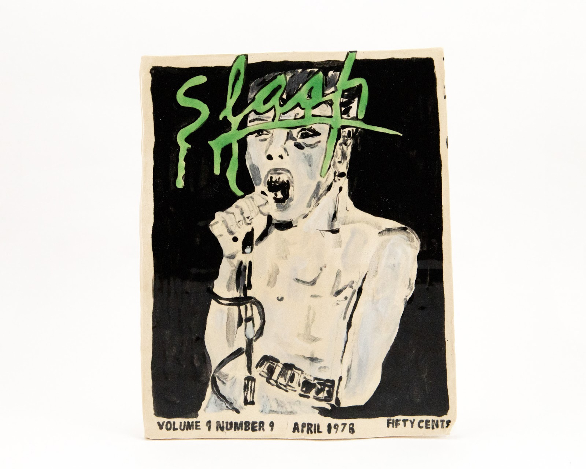 Vintage magazine cover with green "Slash" text dripping above pale figure holding microphone on black background. Aged paper edges visible.