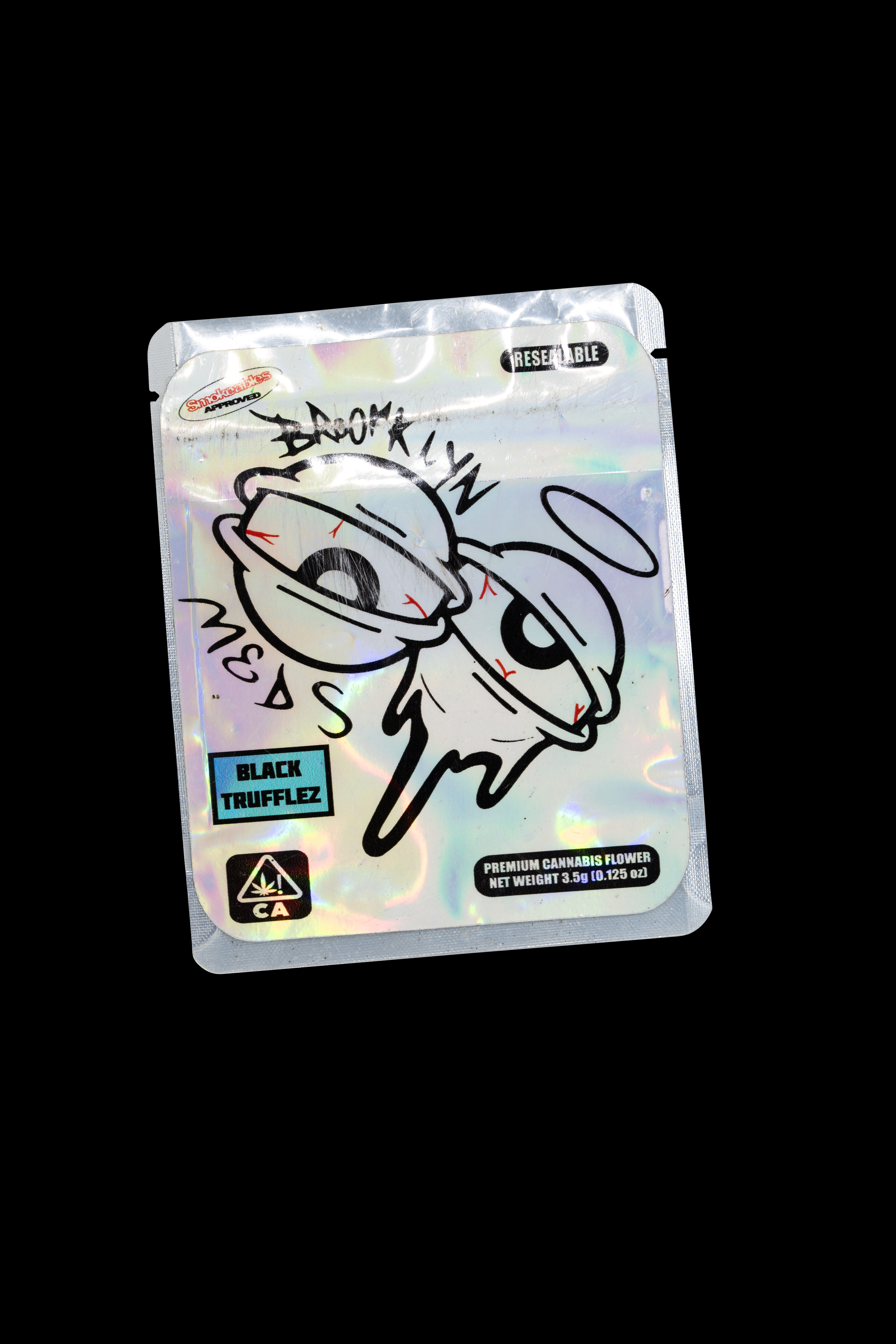 Plastic pouch with cartoon character and text 'Black Trufflez' against black background.