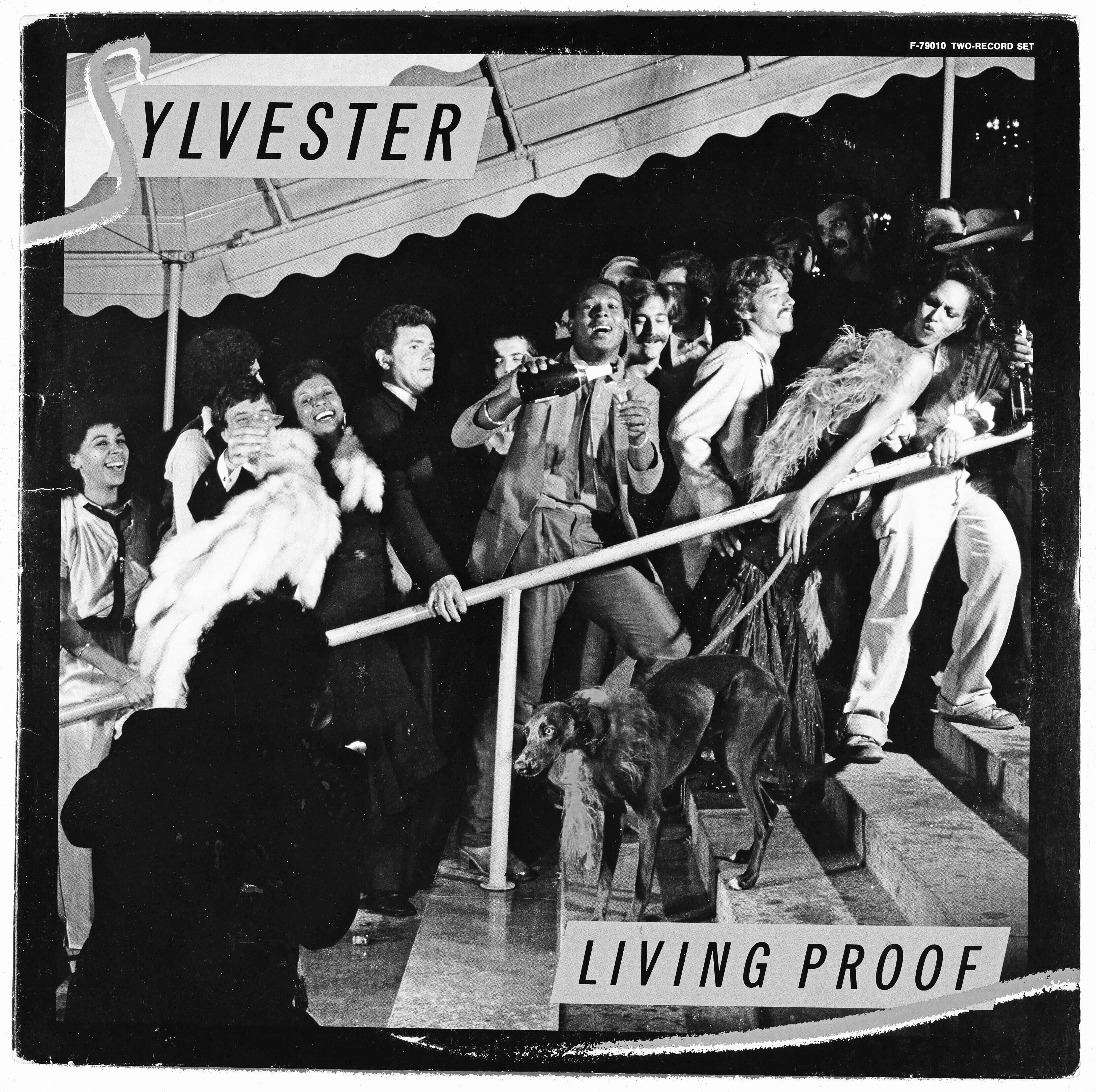 Black and white album cover showing group of people on boat deck with "SYLVESTER" banner above and "LIVING PROOF" text below.