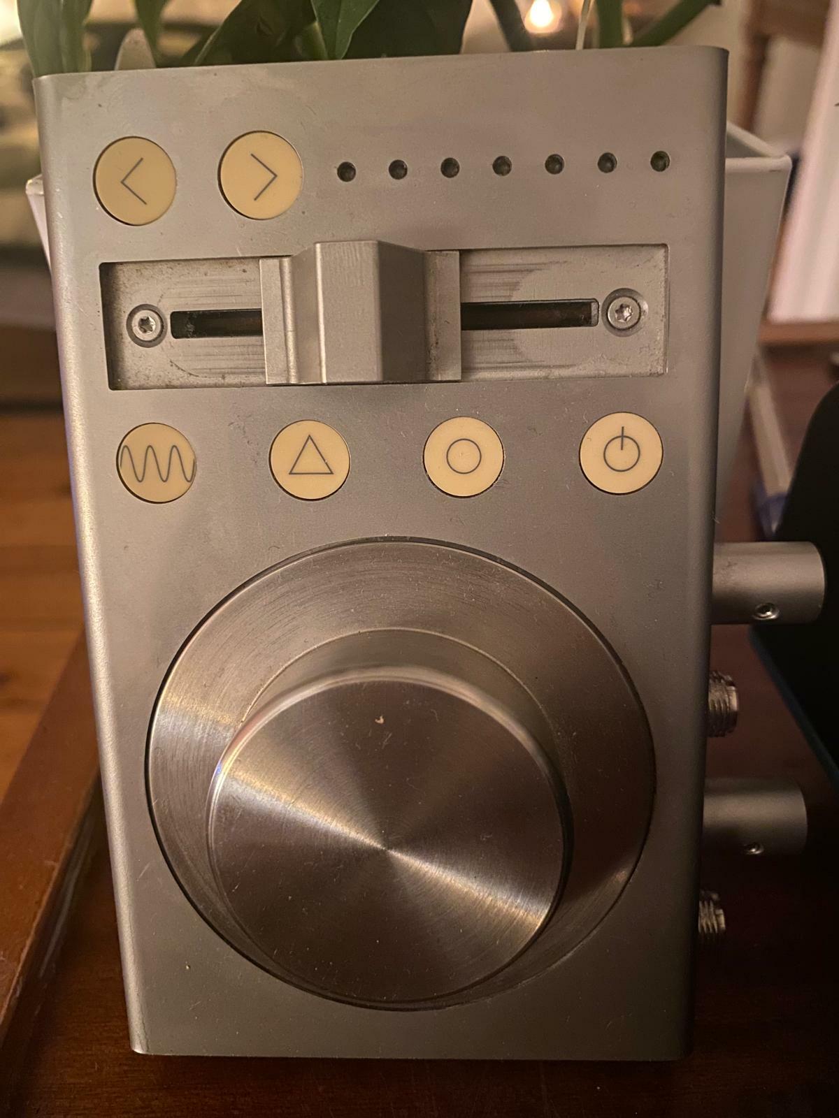Vintage audio component with various buttons and knobs, grey metal casing.