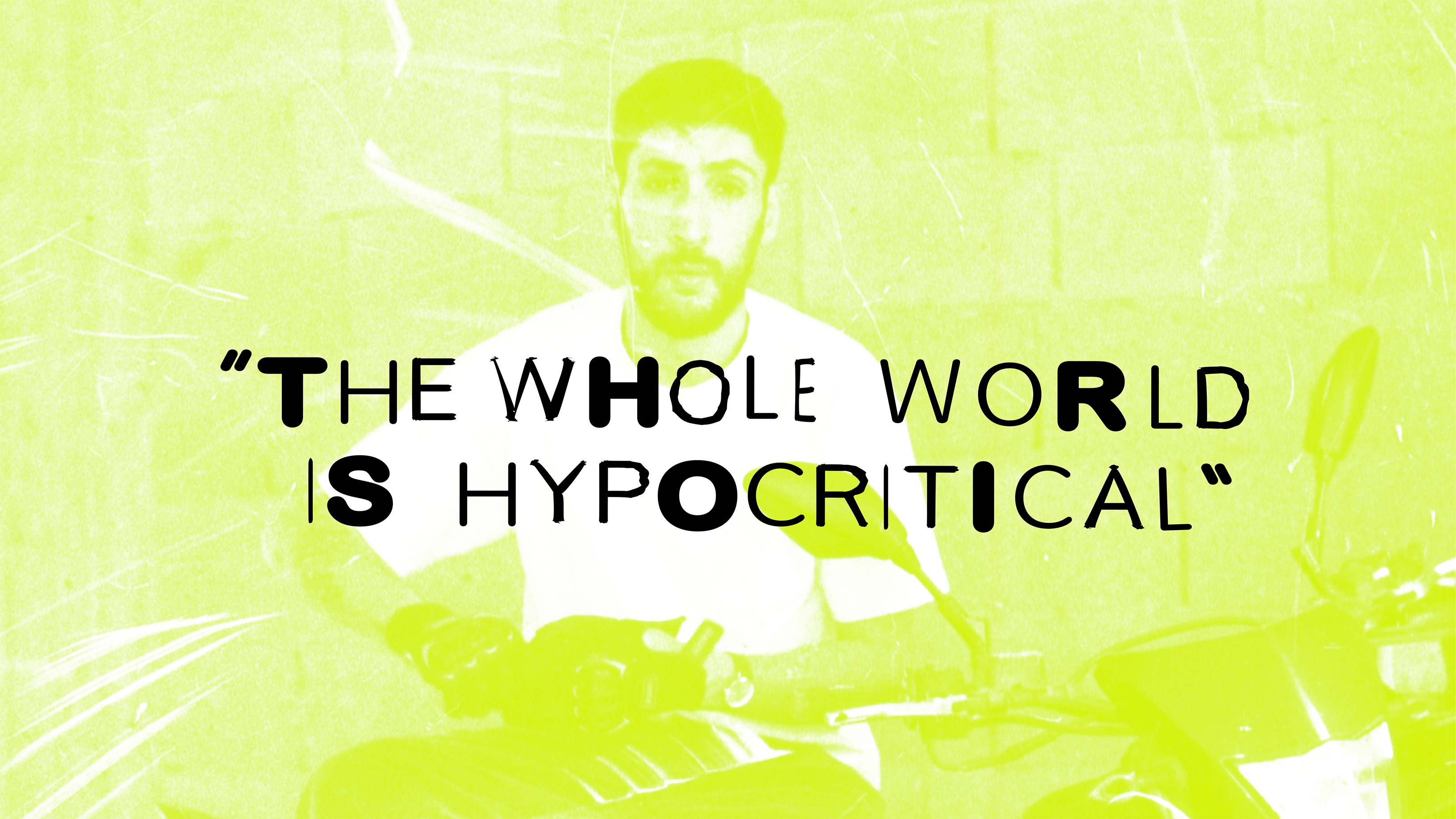 Yellow-green tinted image with seated man figure. Bold black text reads "THE WHOLE WORLD IS HYPOCRITICAL" with select letters highlighted white.