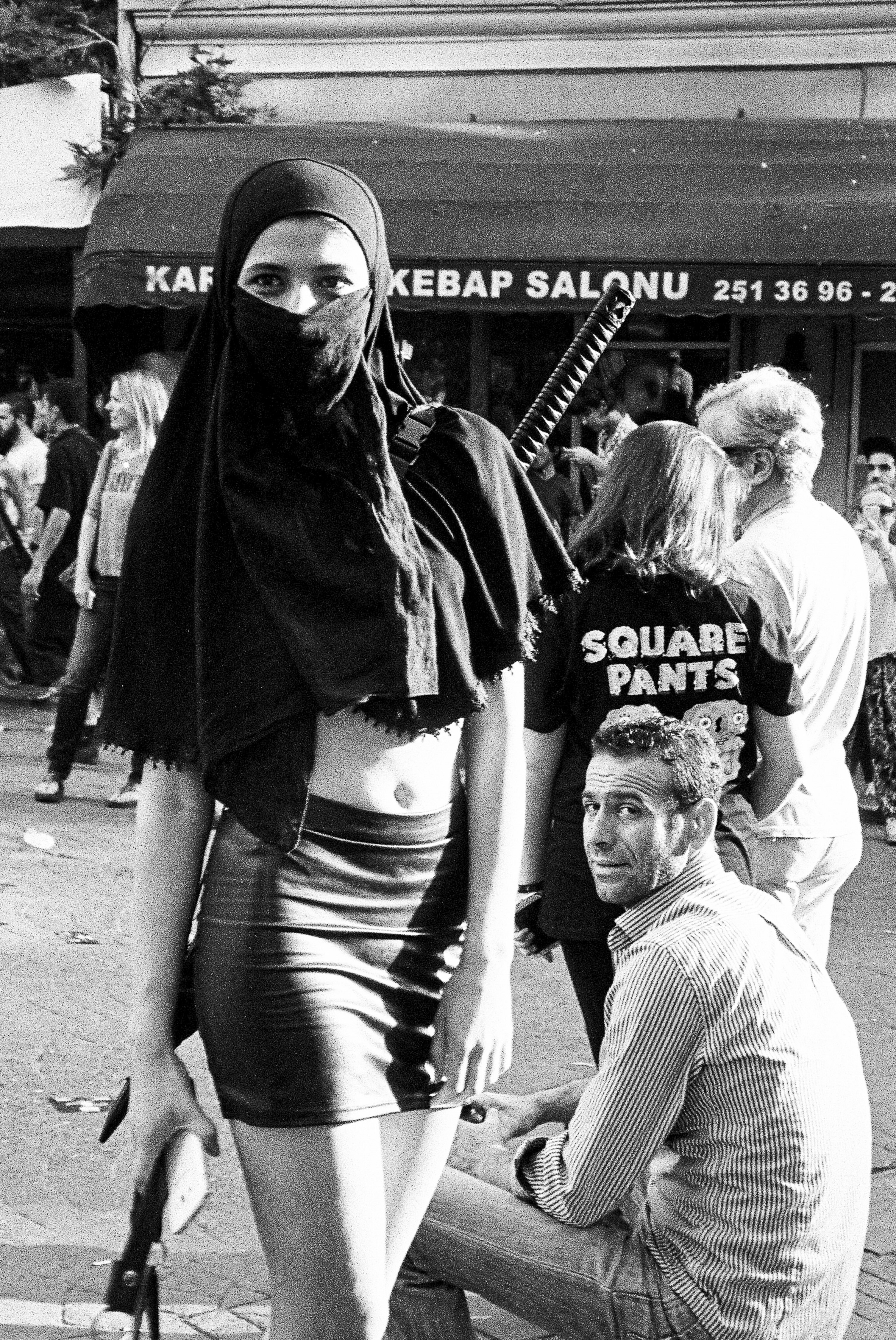 Street scene, persons in traditional dress, shop signage