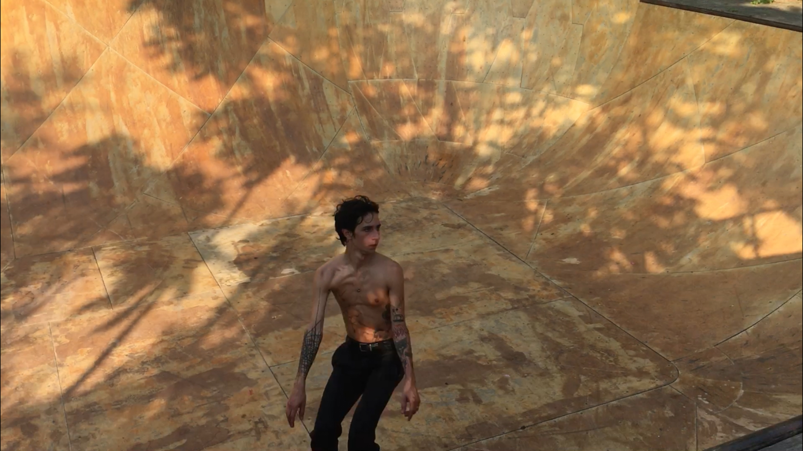 3D rendered figure in red top and dark trousers stands on tiled floor with orange and yellow light patterns projected above.