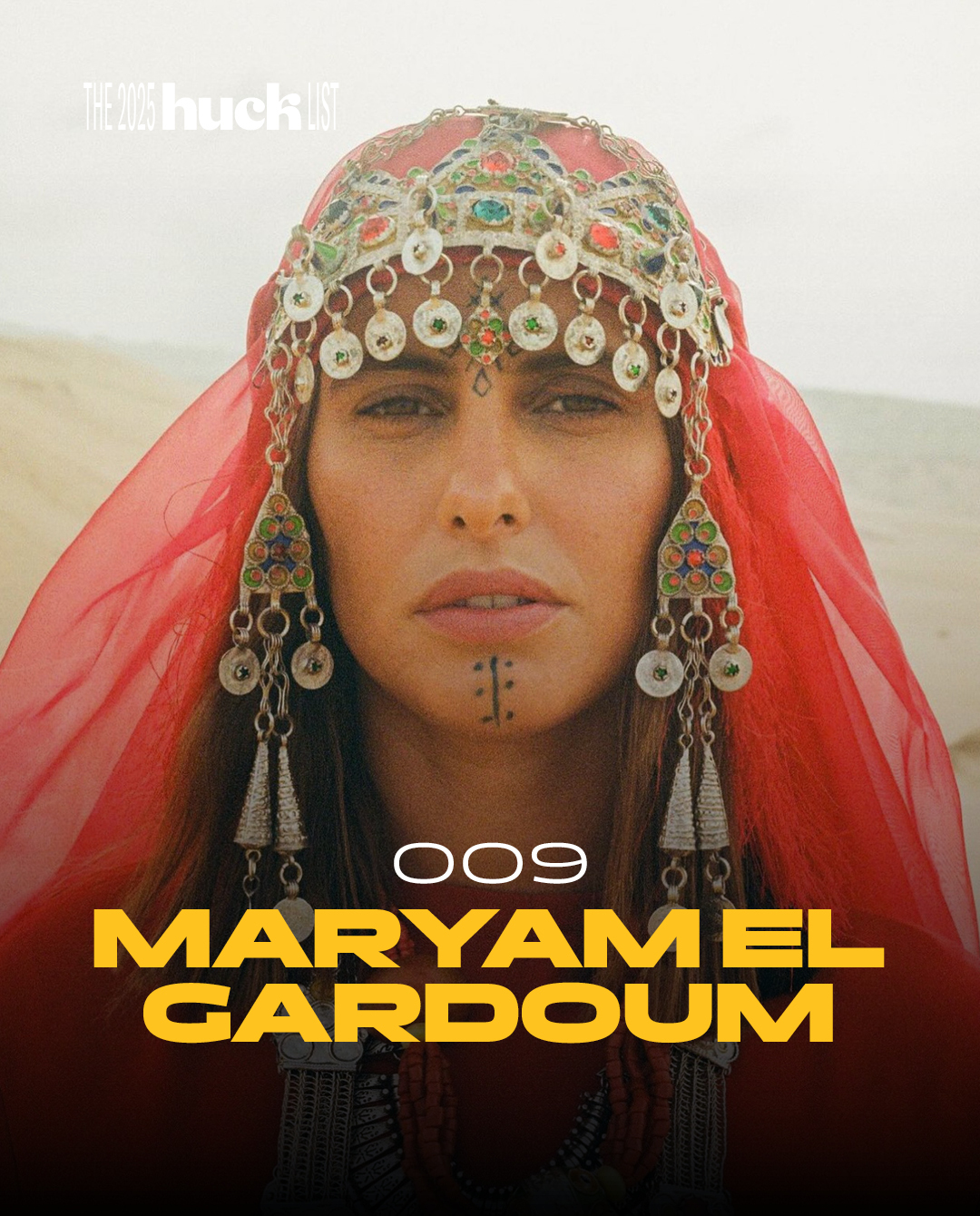 Woman wearing intricate headdress with colourful beads, jewellery, and a red veil.
