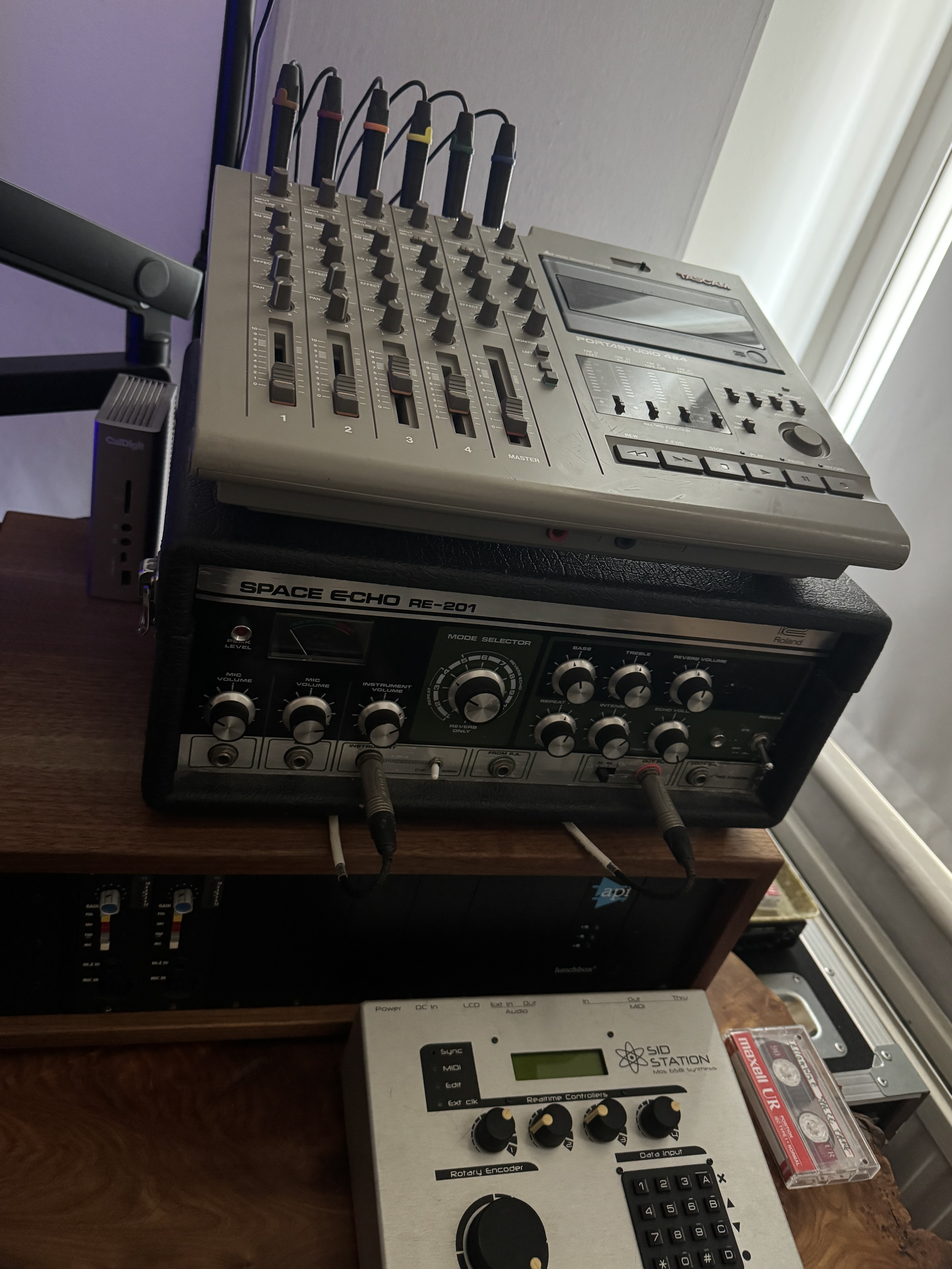 Multi-channel audio mixer and effects unit with various knobs, faders, and buttons on a grey and black exterior.