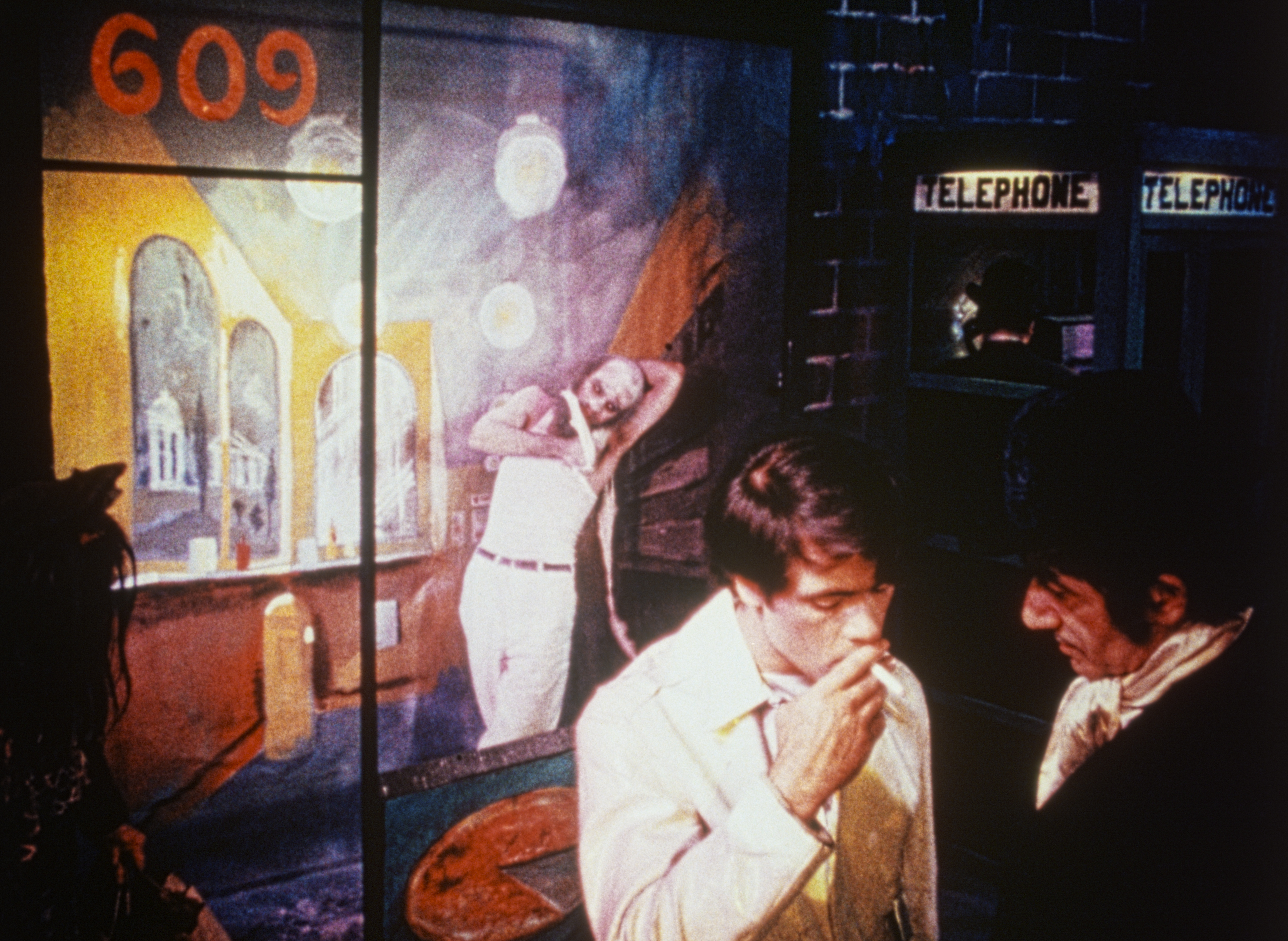 Neon-lit room with abstract mural, phone booths, and figures conversing.