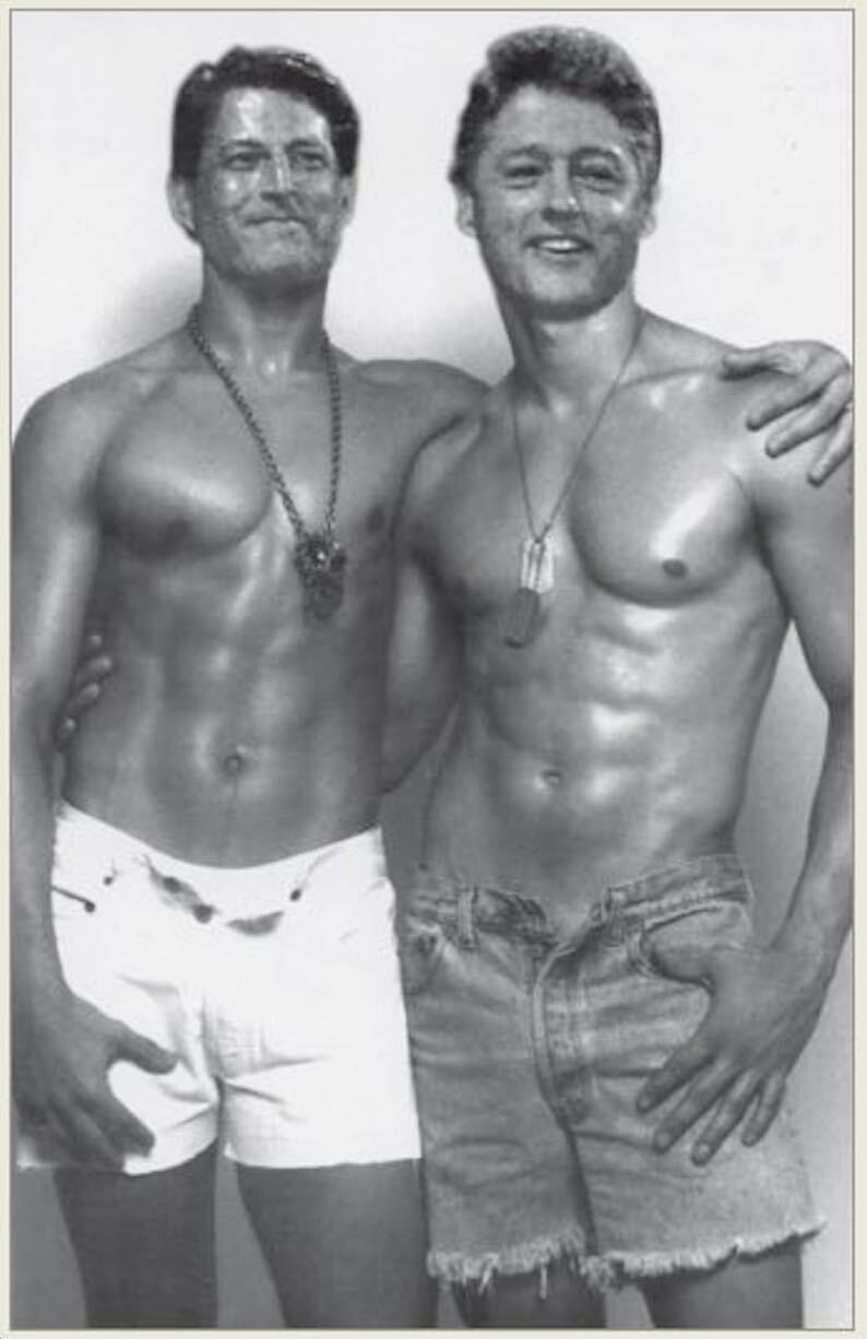 Two shirtless men posing together, showing muscular physiques.