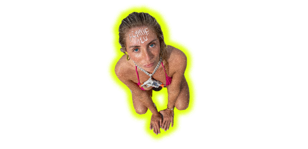 Person with blonde hair in yellow sports bra outlined by bright yellow glow against black background.