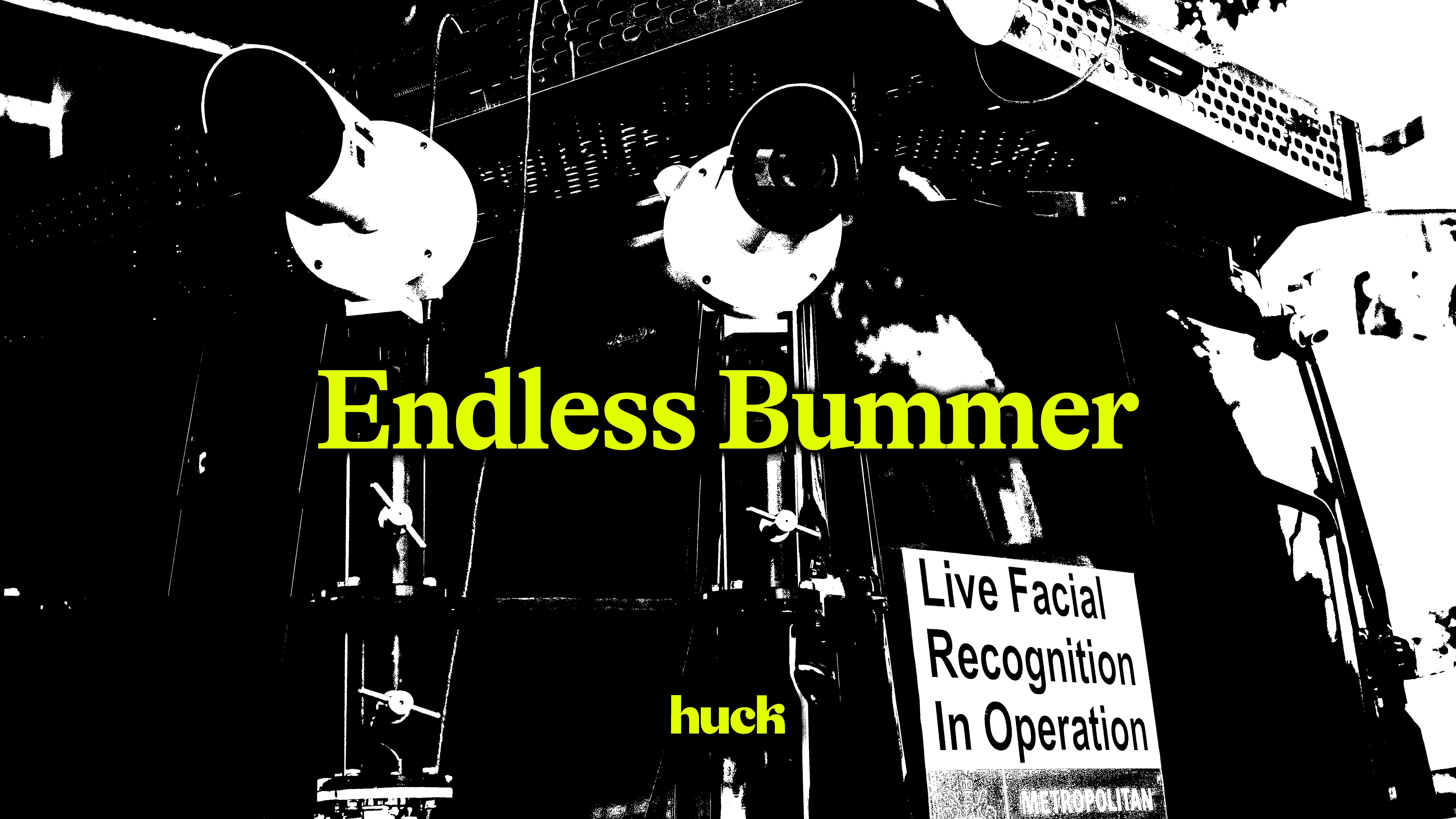 Black and white high-contrast image with yellow text reading "Endless Bummer" and small white sign stating "Live Facial Recognition In Operation".