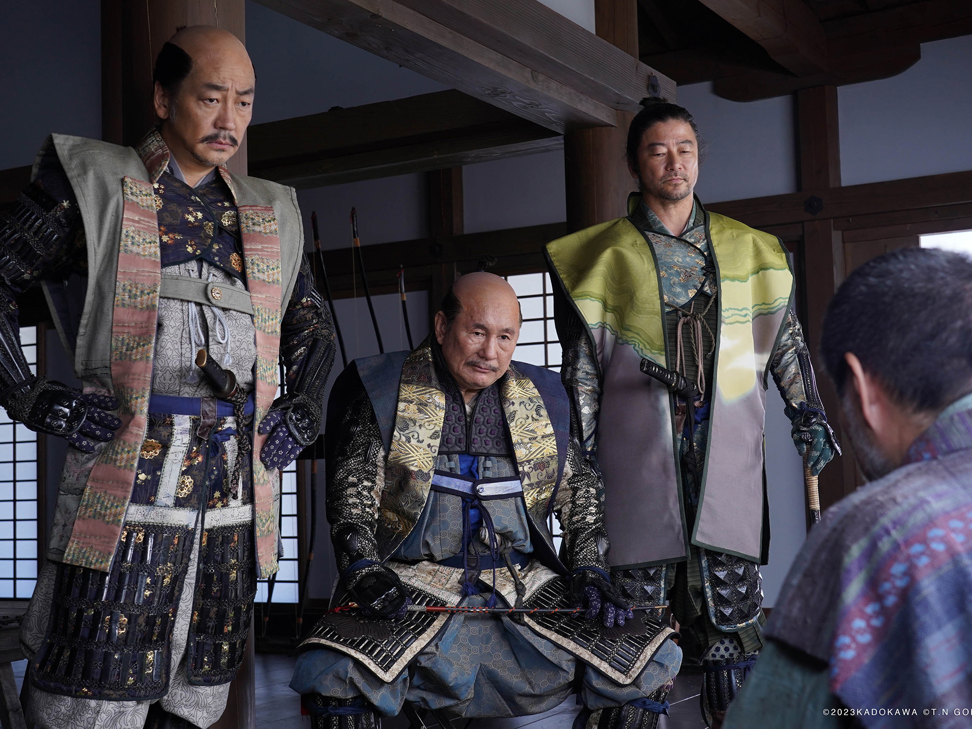 Three men in traditional Japanese samurai armour and clothing, standing in an interior setting.