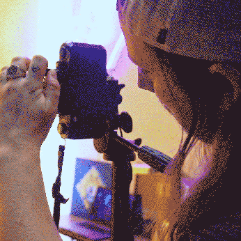 A hand holding a video camera, capturing an image.