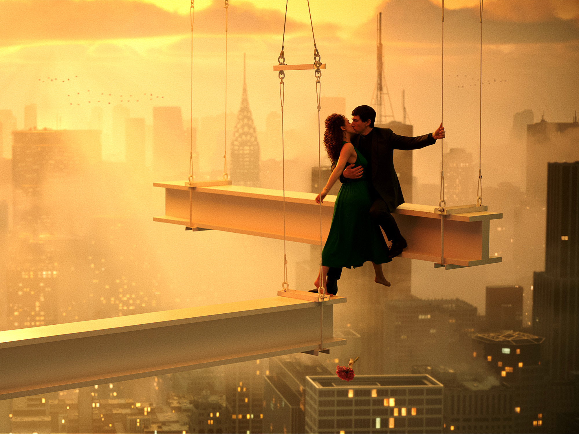 Two figures in dark clothing on suspended wooden platform above cityscape. Warm orange and yellow sky with building silhouettes below.