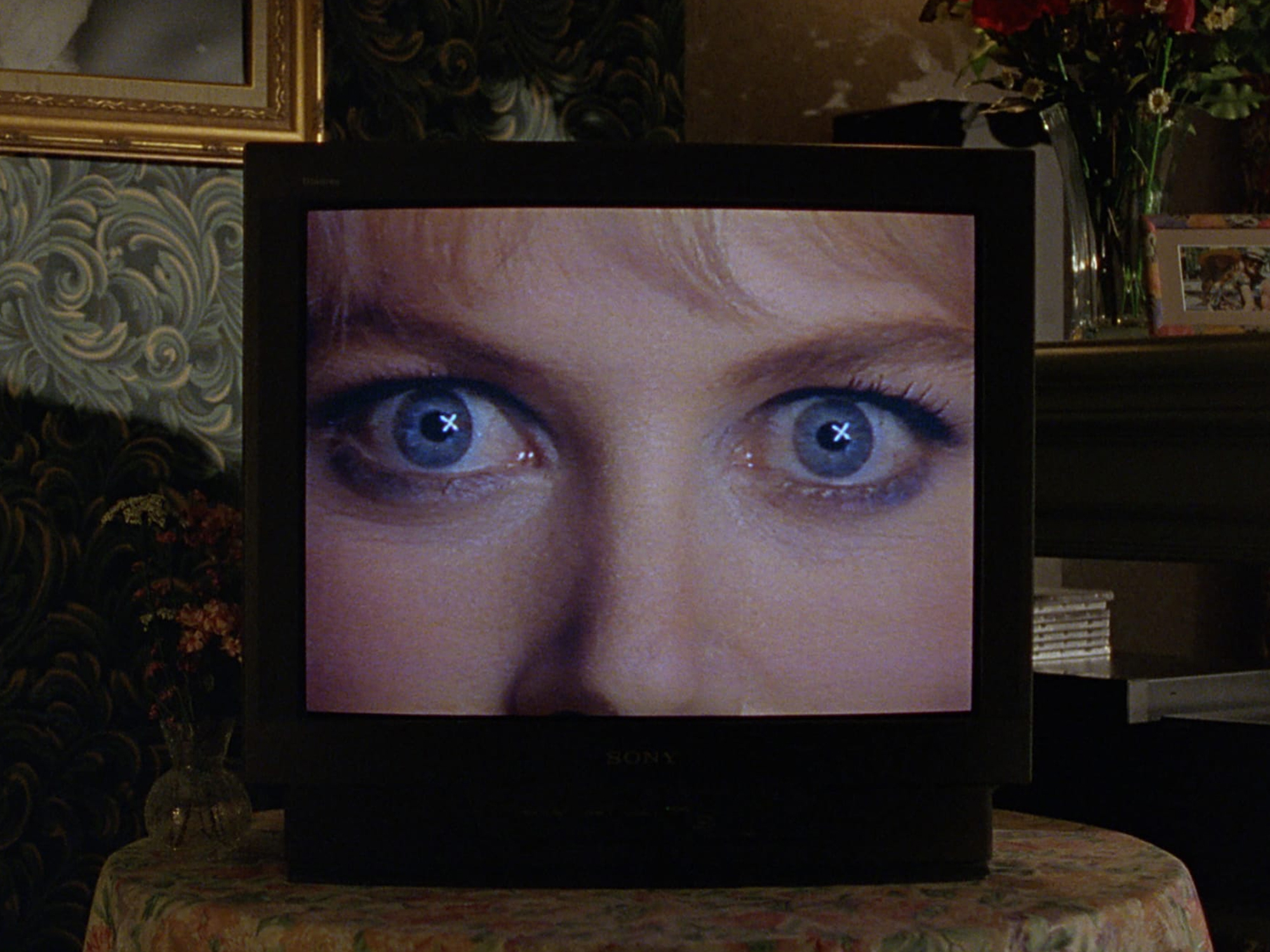 Closeup of Nicole Kidman's blue eyes on a television screen in a living room.